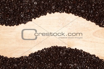 Dark Roasted Coffee Beans on a Wood Textured Background.