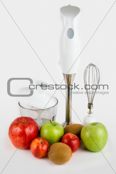 Blender with different ripe fruits