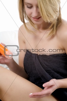 Woman moisturising on sofa