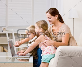 Mother showing children laptop
