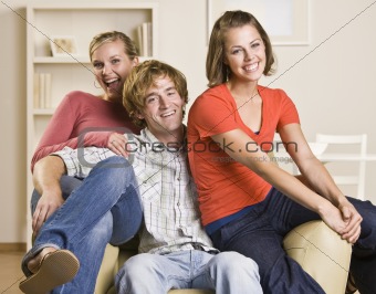 Friends sitting together in chair