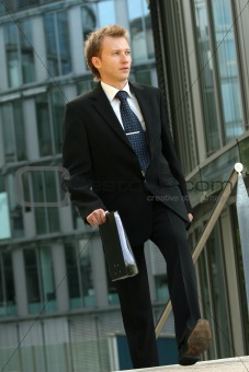 businessman walking with folder