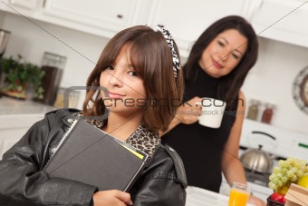 Pretty Hispanic Girl Ready for School with Mom in the Background.
