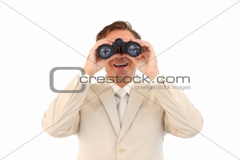 Smiling businessman looking through binoculars 