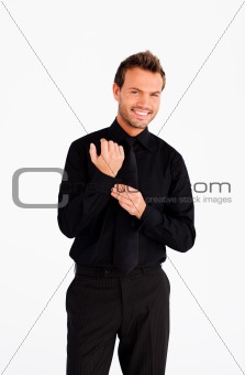 Handsome businessman corrects a cuff link 