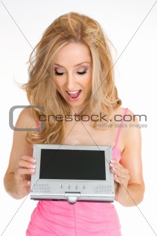 A woman looking down at portable lcd screen