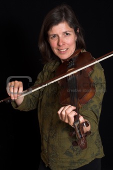 mid-age woman playing violon over black