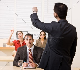 Businessman answering questions in meeting