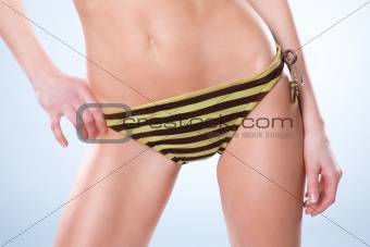 Bottom half of woman wearning a swimsuit