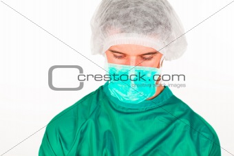Portrait of a surgeon in scrubs uniform looking downwards