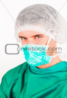 Surgeon with mask and hat on looking at the camera