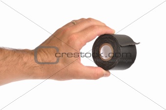 Hand holding black tape, isolated.