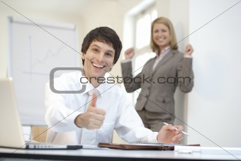 Ceo with buisnesswoman having her arms raised