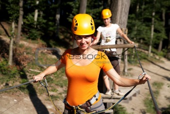 woman wearing professional climbing gear with helmet pulley and carabiner