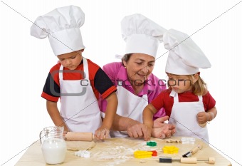 Grandmother teaching kids making cookies