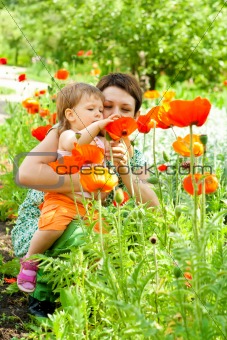 Mother showing flowers to daughter