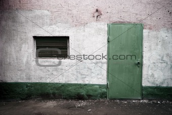 weathered wall with green door