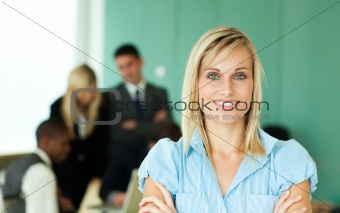 Businesswoman in front of people working in an office