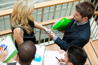 Business team discussing about reports and documents on stairs