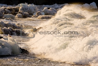 Surf breaking on an ice strewn beach
