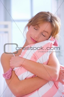 Woman embracing pillow