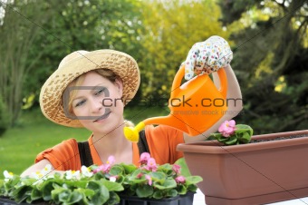 Young woman watering flowers