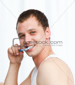 Attractive man cleaning teeth