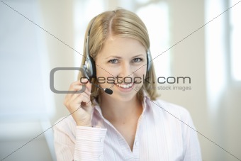 Blond businesswoman with headphone