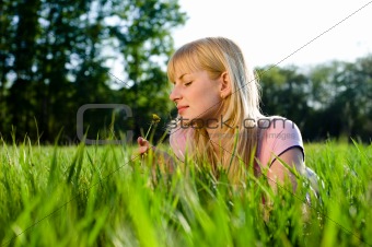 Girl smells a dandelion