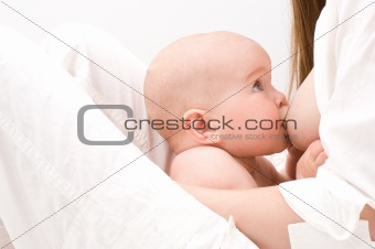 Closeup little baby breast feeding.