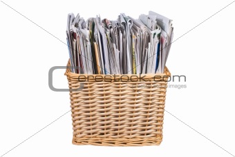 Wicker basket with newspapers and catalogs