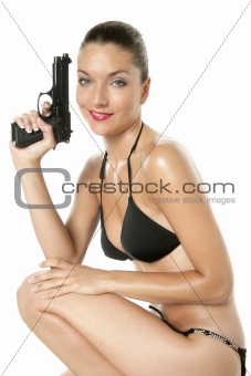 Beautiful sexy woman with black bikini and gun