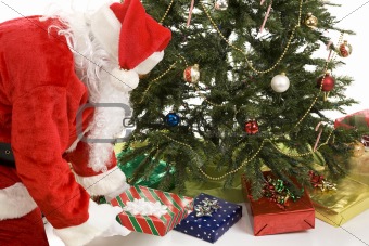 Santa Puts Gifts Under Tree