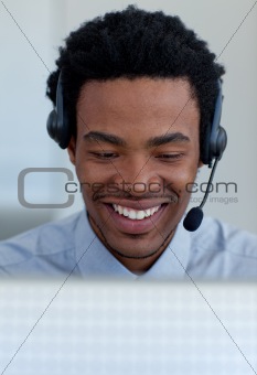 Smiling Afro-American businessman talking in a call center