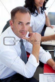 Businessman in a meeting looking at the camera