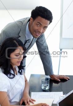 Afro-American businessman helping his colleague