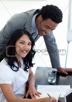 Afro-American businessman talking to his colleague