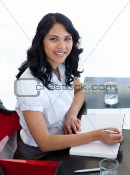 Businesswoman taking notes in a meeting