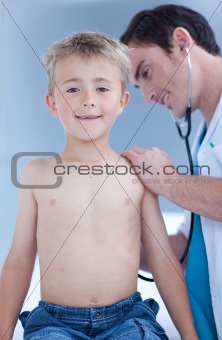Smiling examinating a child with stethoscope