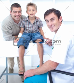 Doctor checking a boy reflexes