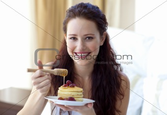 Happy woman eating a sweet dessert