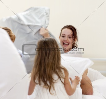 Mother and children having a pillow fight