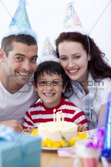 Little boy celebrating his birthday with his parents