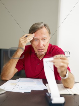 Senior man checking home finances