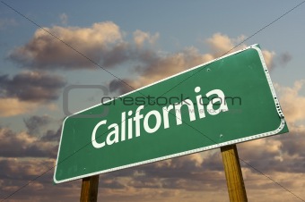 California Green Road Sign with dramatic blue sky and clouds.