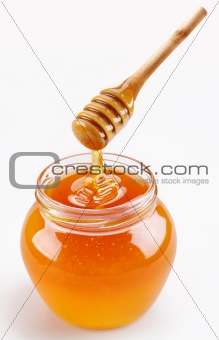 Full honey pot and honey stick