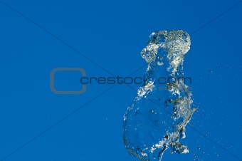 Fountain of pure water over blue clear sky