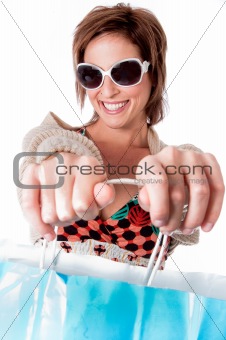 Happy young woman with shopping bags on white