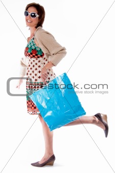 Happy young woman with shopping bags on white