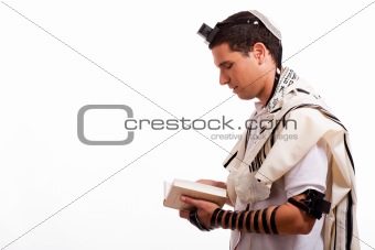 Side view of young  jewish man with book